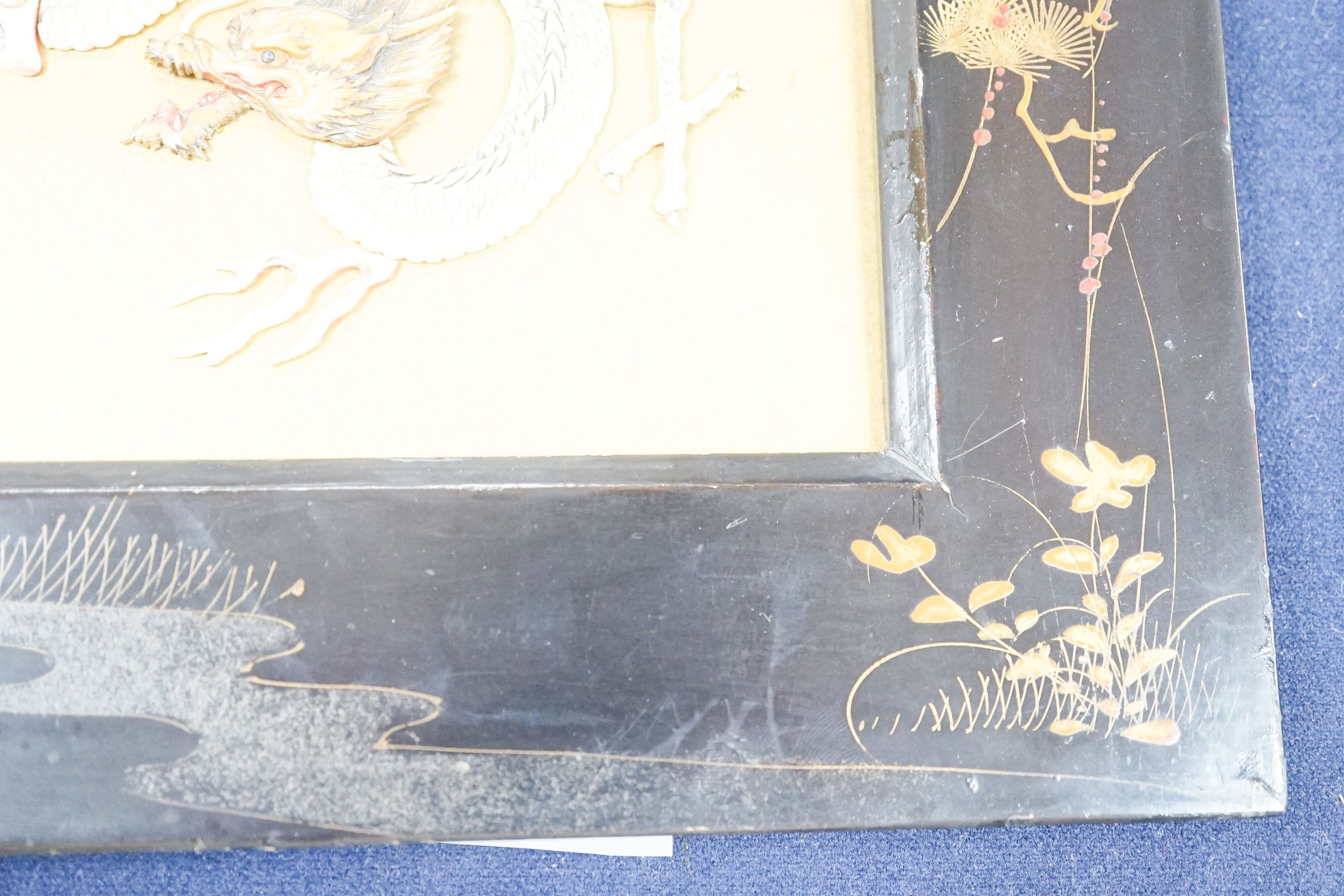 A Japanese bone ‘dragon’ and lacquer framed panel, early 20th century, 31 x 37 cm